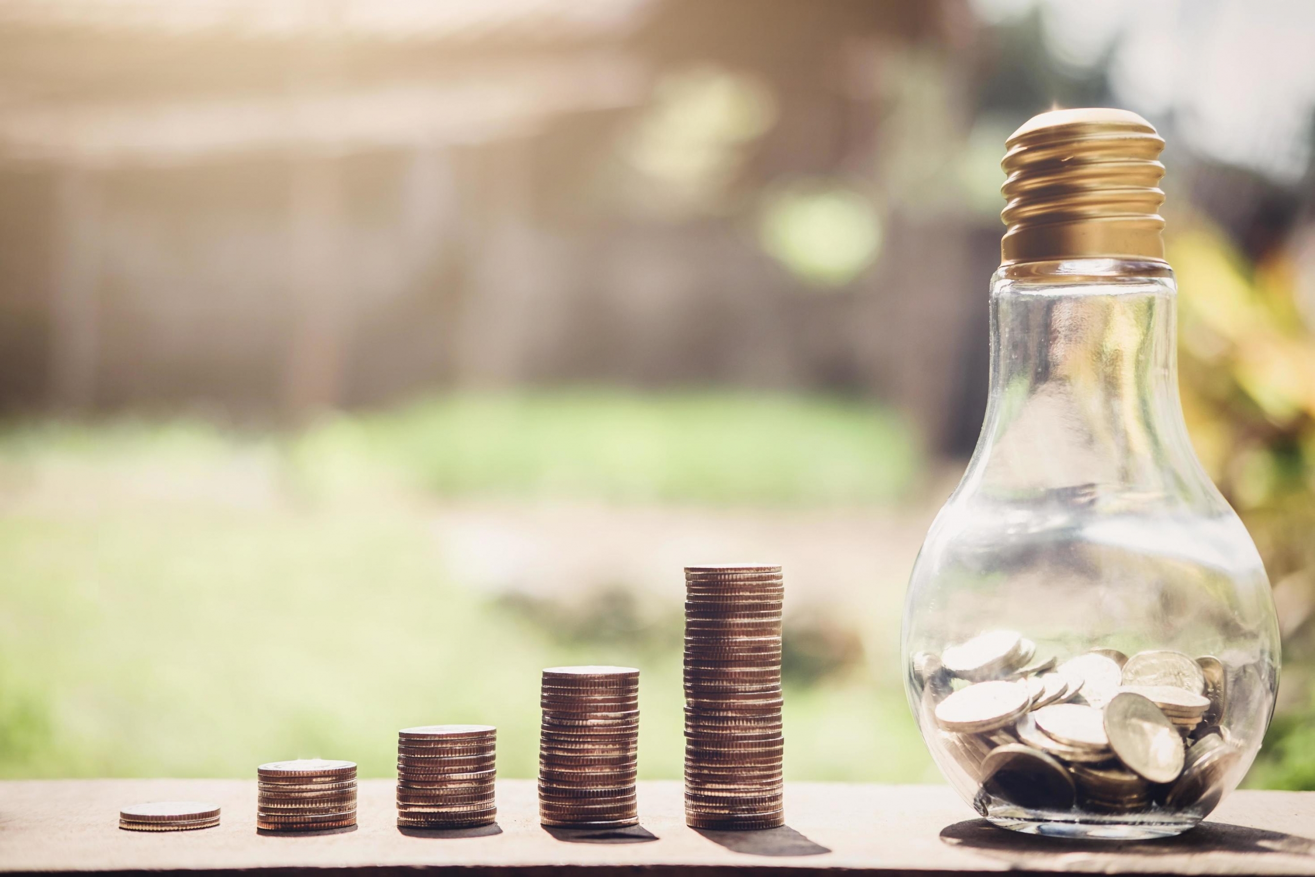 stacks-of-coins-with-lightbulb-with-coins-in-it-free-photo